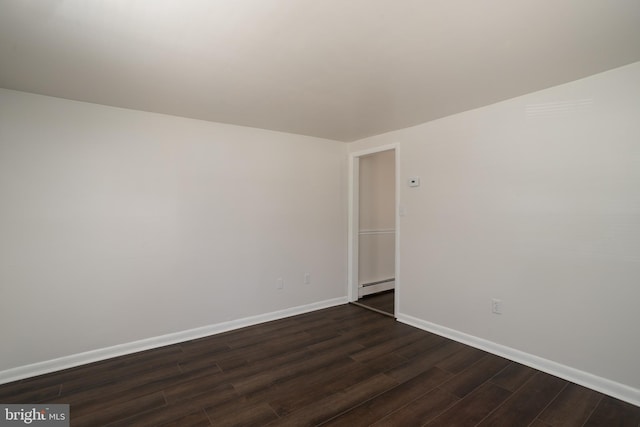 218 Elizabeth St, Bordentown, NJ 08505 - spare room featuring a baseboard heating unit, dark wood-style flooring, and baseboards