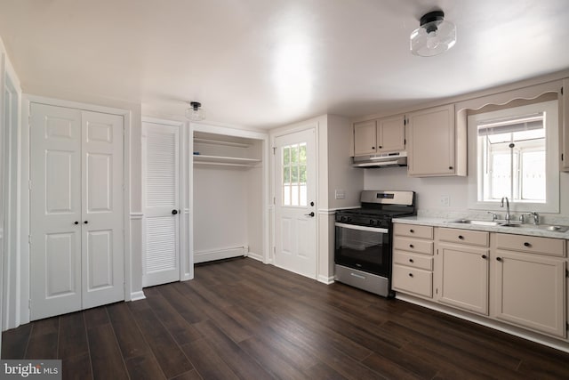 218 Elizabeth St, Bordentown, NJ 08505 - kitchen featuring stainless steel range with gas cooktop, a sink, a baseboard radiator, under cabinet range hood, and light countertops