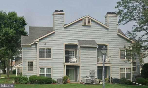 161 Andover Pl, Robbinsville, NJ 08691 - back of property featuring a chimney, a yard, and central AC