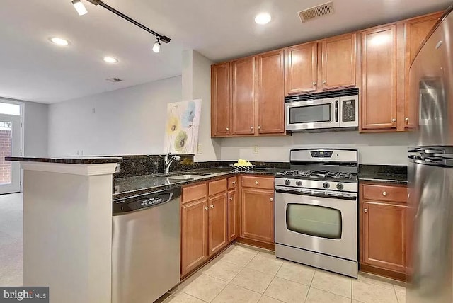 2665 Prosperity Ave Unit 6, Fairfax, VA 22031 - kitchen with appliances with stainless steel finishes, a sink, a peninsula, light tile patterned floors, and dark stone counters