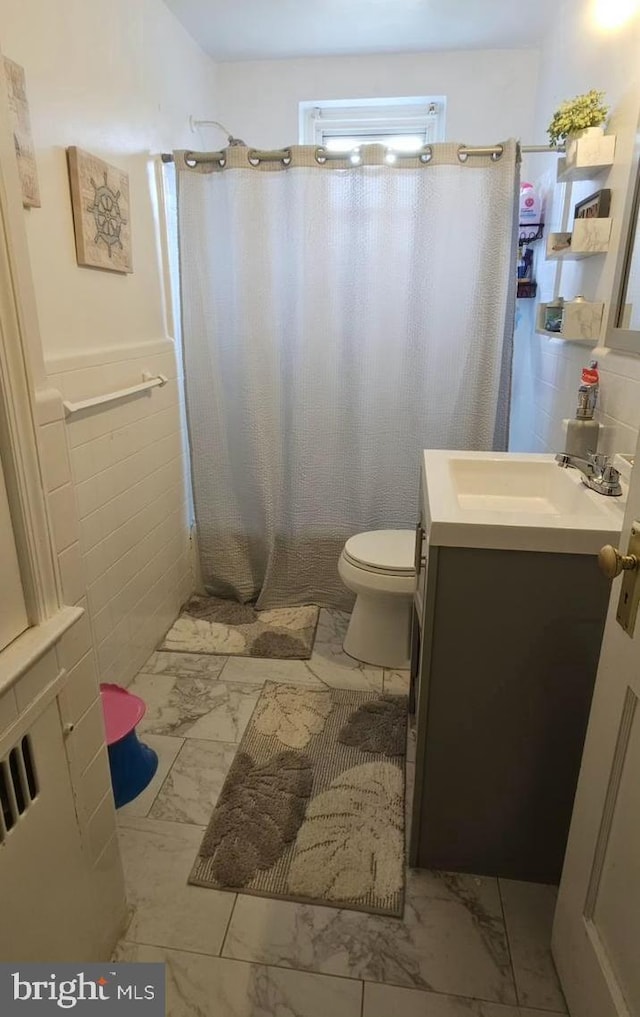 6517 Montour St, Philadelphia, PA 19111 - bathroom featuring marble look tiles, vanity, toilet, and curtained shower