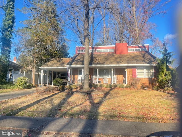 633 S Edge Park Dr, Haddonfield, NJ 8033 - view of front facade with covered porch, brick siding, asphalt driveway, a carport, and a front yard