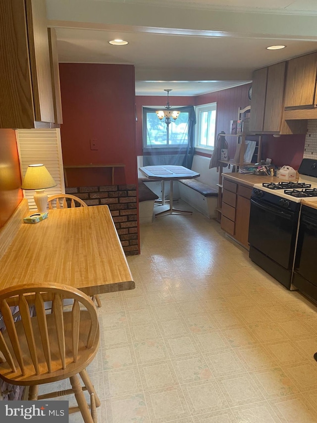 808 W Penn Pines Blvd, Aldan, PA 19018 - kitchen featuring gas range oven, light flooring, a chandelier, and hanging light fixtures