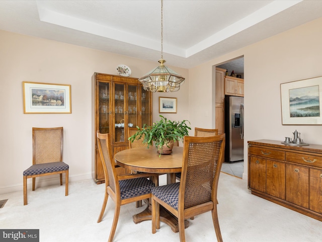 228 Sunset Cir, Cross Junction, VA 22625 - dining area with a chandelier, a tray ceiling, light colored carpet, and baseboards