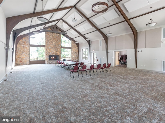 228 Sunset Cir, Cross Junction, VA 22625 - dining room with high vaulted ceiling, carpet, beamed ceiling, a stone fireplace, and baseboards