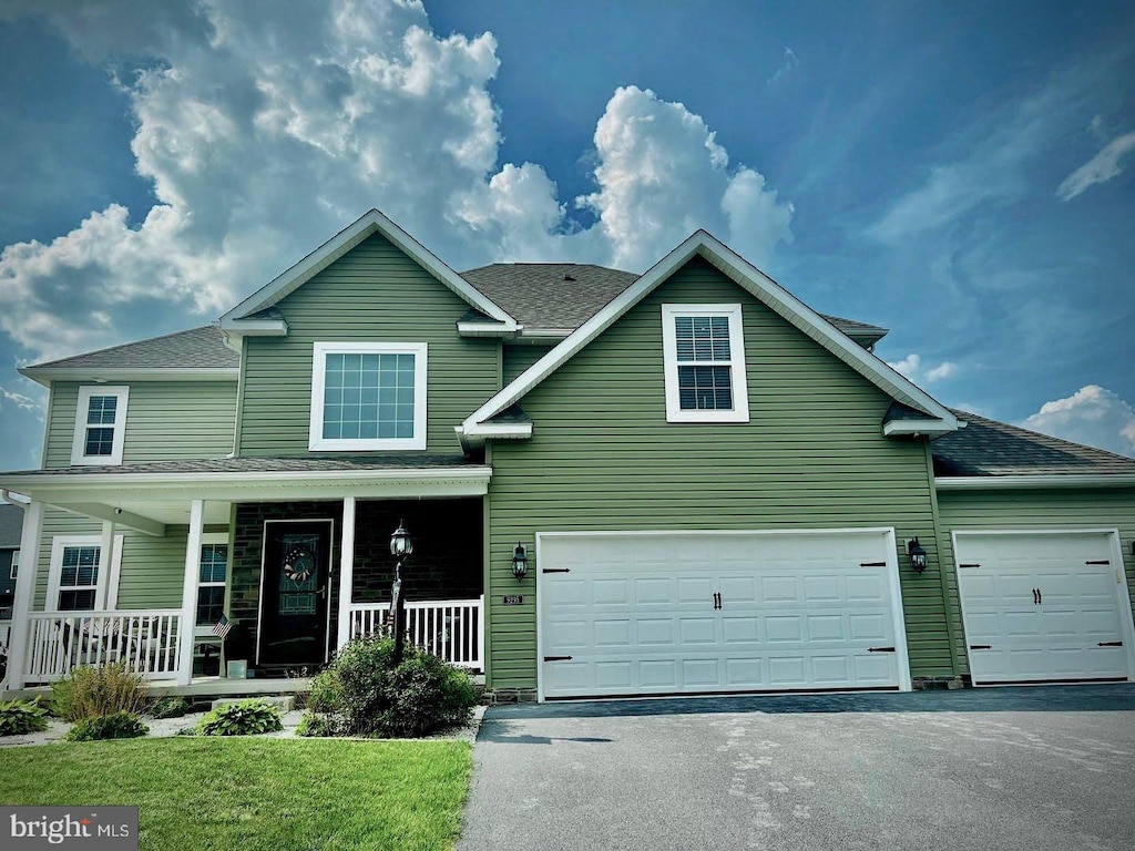 9295 Lindale Ave, Greencastle, PA 17225 - traditional-style house with driveway, covered porch, a garage, and roof with shingles