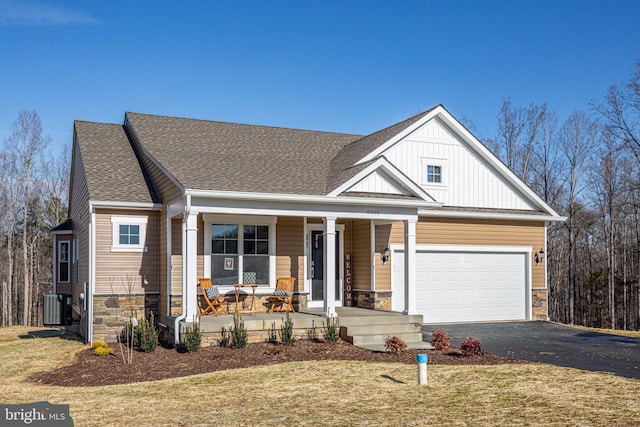 7443 Long Leaf Ln, King George, VA 22485 - view of front of property featuring stone siding, a porch, asphalt driveway, and board and batten siding