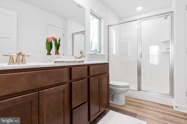 7443 Long Leaf Ln, King George, VA 22485 - bathroom featuring a shower stall, toilet, double vanity, wood finished floors, and recessed lighting