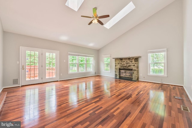 1176 Bandy Run Rd, Herndon, VA 20170 - unfurnished living room featuring a skylight, healthy amount of natural light, high vaulted ceiling, hardwood / wood-style floors, and a stone fireplace