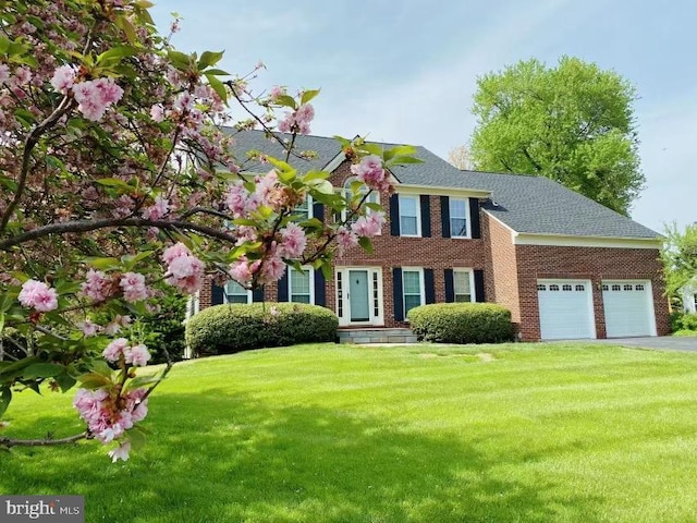 1176 Bandy Run Rd, Herndon, VA 20170 - colonial home featuring an attached garage, a front yard, asphalt driveway, brick siding, and roof with shingles