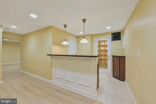 1176 Bandy Run Rd, Herndon, VA 20170 - kitchen featuring dark countertops, baseboards, recessed lighting, hanging light fixtures, and a kitchen bar
