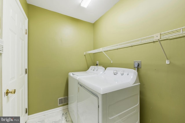 1176 Bandy Run Rd, Herndon, VA 20170 - laundry room with washing machine and dryer, light marble finish flooring, and baseboards
