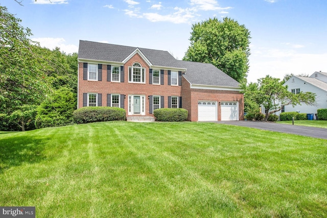 1176 Bandy Run Rd, Herndon, VA 20170 - colonial-style house featuring a garage, driveway, a front lawn, and brick siding