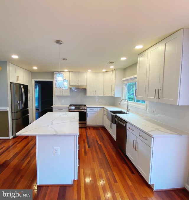 1176 Bandy Run Rd, Herndon, VA 20170 - kitchen featuring stainless steel appliances, a sink, dark wood finished floors, light stone countertops, and a kitchen island