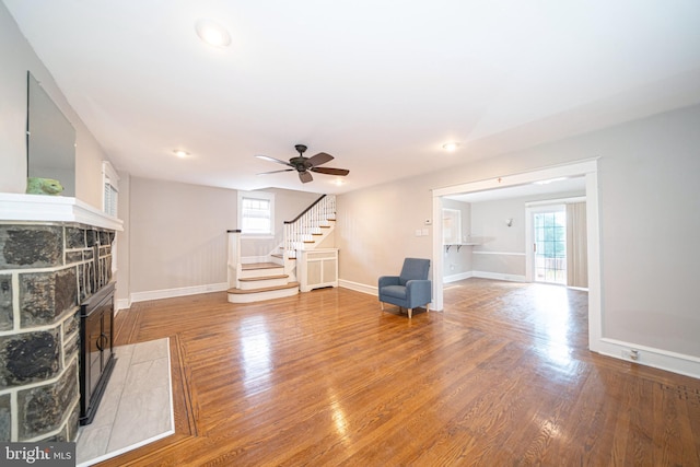 27 Shelbourne Rd, Havertown, PA 19083 - unfurnished living room with healthy amount of natural light, stairs, a fireplace, wood finished floors, and recessed lighting
