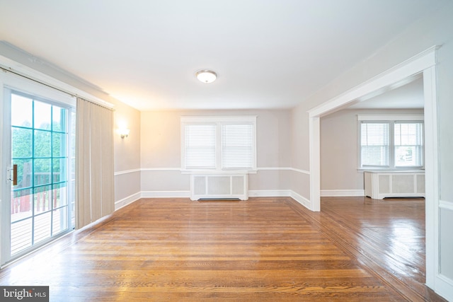 27 Shelbourne Rd, Havertown, PA 19083 - spare room with wood finished floors, radiator heating unit, and baseboards