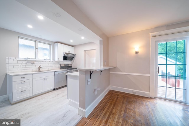 27 Shelbourne Rd, Havertown, PA 19083 - kitchen with a sink, appliances with stainless steel finishes, baseboards, light wood finished floors, and recessed lighting