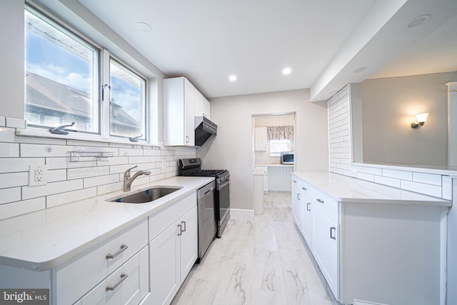 27 Shelbourne Rd, Havertown, PA 19083 - kitchen featuring light marble finish floors, stainless steel appliances, a sink, tasteful backsplash, and light stone counters