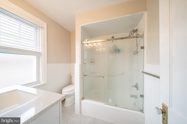 27 Shelbourne Rd, Havertown, PA 19083 - full bathroom featuring tile walls, vanity, toilet, tile patterned floors, and wainscoting