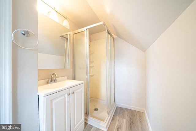 27 Shelbourne Rd, Havertown, PA 19083 - bathroom featuring vaulted ceiling, wood finished floors, vanity, and a shower stall