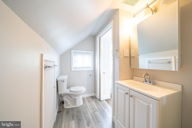 27 Shelbourne Rd, Havertown, PA 19083 - bathroom with wood finished floors, toilet, vanity, lofted ceiling, and baseboards