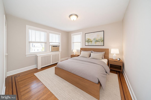 27 Shelbourne Rd, Havertown, PA 19083 - bedroom featuring radiator heating unit, wood finished floors, baseboards, and cooling unit