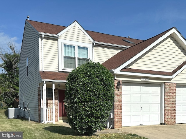 22565 Upper Kells Ln, Great Mills, MD 20634 - traditional-style home with brick siding, an attached garage, driveway, and central air condition unit