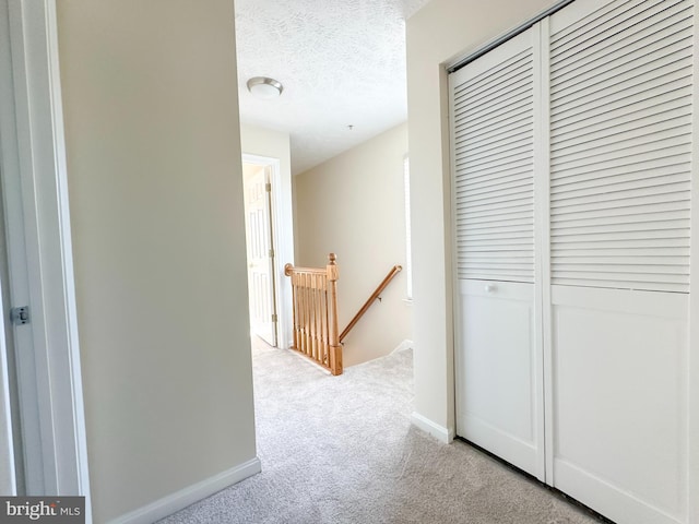 22565 Upper Kells Ln, Great Mills, MD 20634 - corridor featuring an upstairs landing, light colored carpet, a textured ceiling, and baseboards