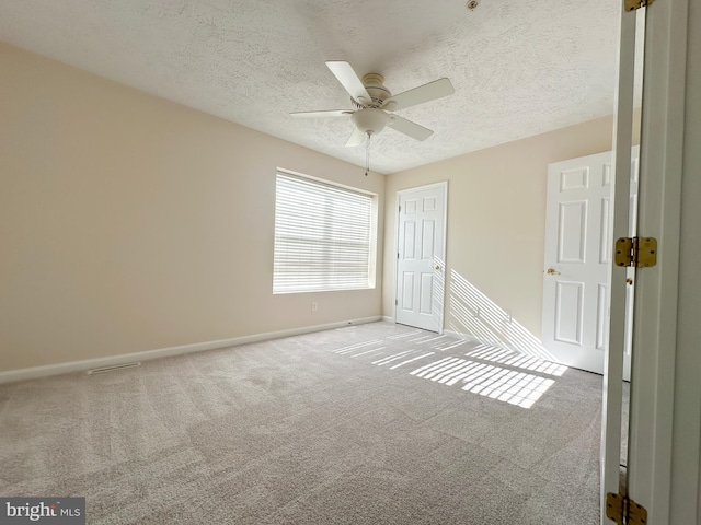 22565 Upper Kells Ln, Great Mills, MD 20634 - unfurnished bedroom featuring carpet, a textured ceiling, baseboards, a closet, and a ceiling fan