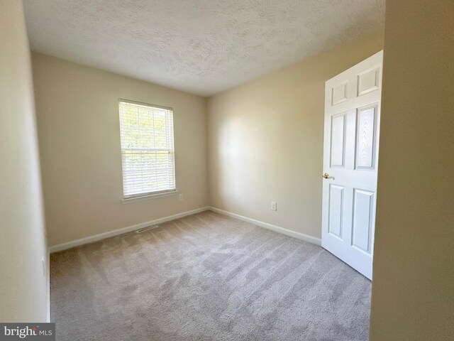 22565 Upper Kells Ln, Great Mills, MD 20634 - spare room featuring a textured ceiling, carpet floors, and baseboards