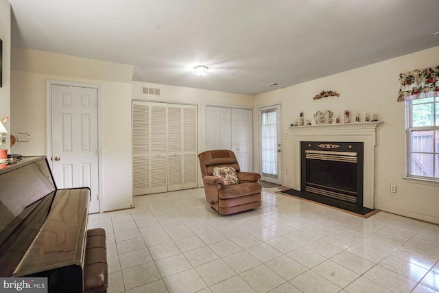 4057 Glostonbury Way, Fairfax, VA 22030 - living area featuring light tile patterned flooring, a fireplace with raised hearth, and baseboards