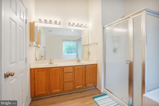 4057 Glostonbury Way, Fairfax, VA 22030 - full bathroom with a stall shower, double vanity, and wood finished floors