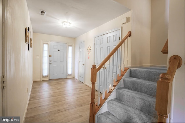 4057 Glostonbury Way, Fairfax, VA 22030 - entryway with light wood-style floors, stairs, and baseboards