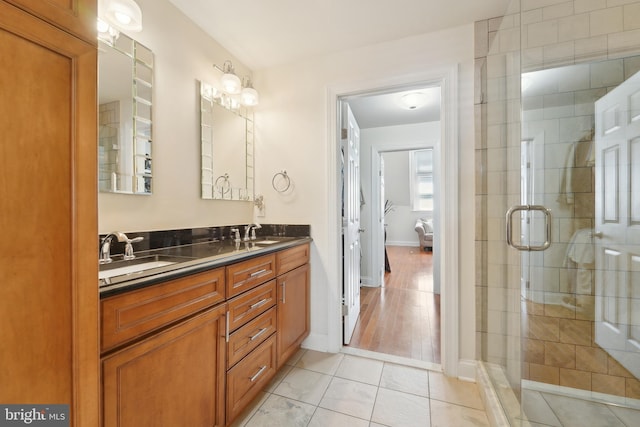 14 E Preston St, Baltimore, MD 21202 - full bathroom with double vanity, a stall shower, baseboards, and tile patterned floors