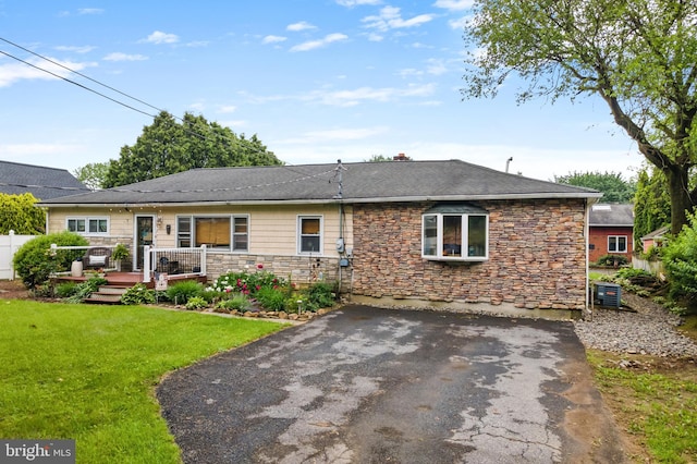 4203 William Penn Hwy, Easton, PA 18045 - rear view of property with a deck, stone siding, driveway, and central AC unit