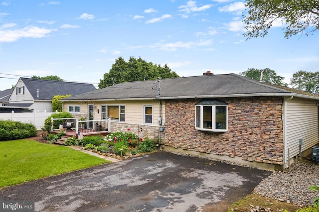 4203 William Penn Hwy, Easton, PA 18045 - back of house featuring stone siding, a wooden deck, a chimney, and roof with shingles