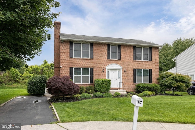 12 Dandelion Ct, Owings Mills, MD 21117 - colonial home with a chimney, brick siding, and a front lawn