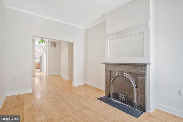 743 W Cross St, Baltimore, MD 21230 - unfurnished living room featuring ornamental molding, a fireplace with flush hearth, and light wood-style flooring