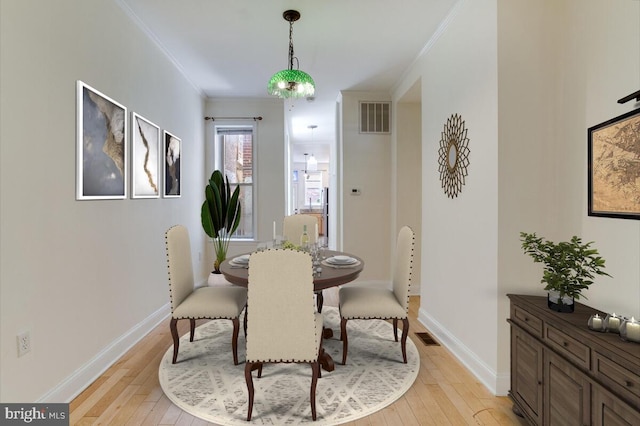 743 W Cross St, Baltimore, MD 21230 - dining space with crown molding and light wood-style floors