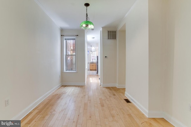 743 W Cross St, Baltimore, MD 21230 - unfurnished dining area with crown molding and light wood-style flooring