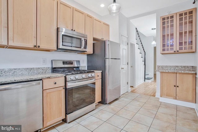 743 W Cross St, Baltimore, MD 21230 - kitchen with stainless steel appliances, light brown cabinetry, light tile patterned flooring, glass insert cabinets, and light stone countertops