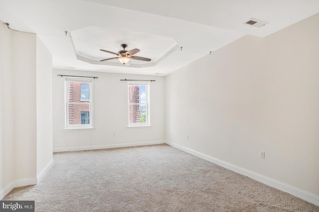 743 W Cross St, Baltimore, MD 21230 - spare room featuring a tray ceiling, light carpet, and ceiling fan