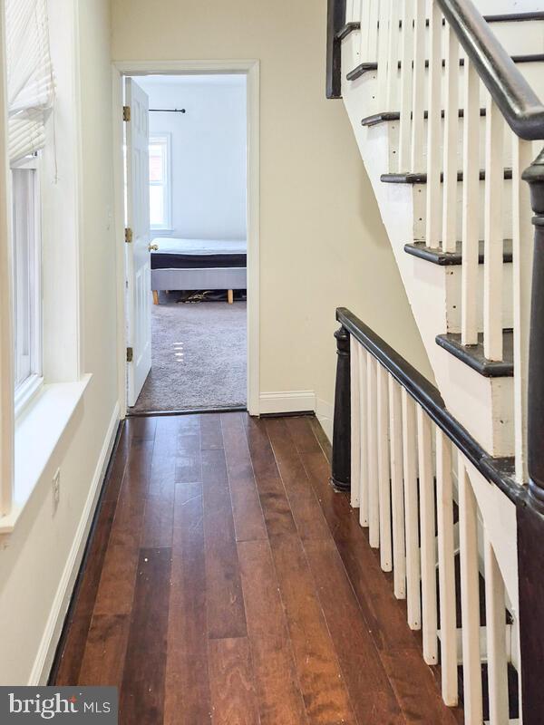 743 W Cross St, Baltimore, MD 21230 - stairway with wood-type flooring and baseboards