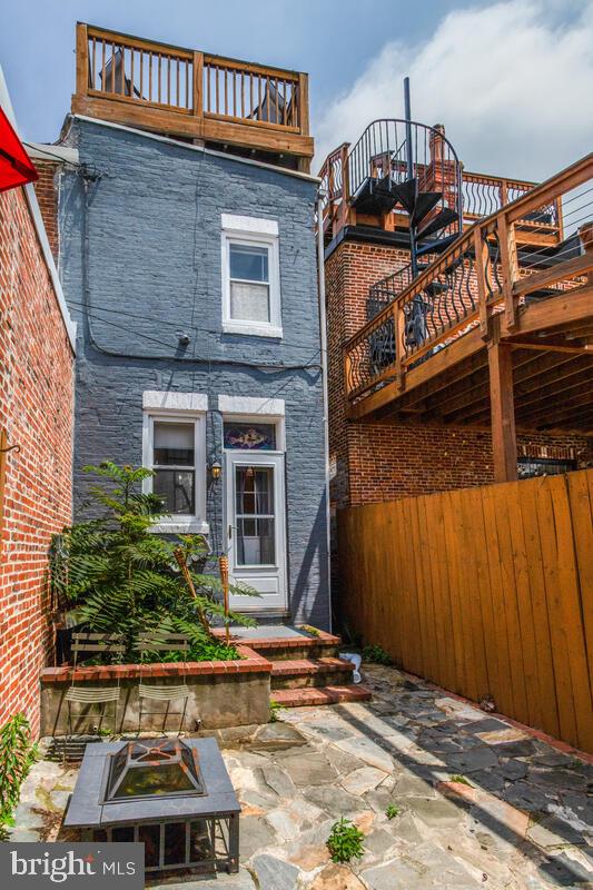 743 W Cross St, Baltimore, MD 21230 - rear view of property with brick siding, a balcony, and a patio