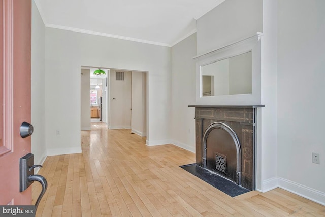743 W Cross St, Baltimore, MD 21230 - unfurnished living room featuring a fireplace with flush hearth, ornamental molding, and hardwood / wood-style floors
