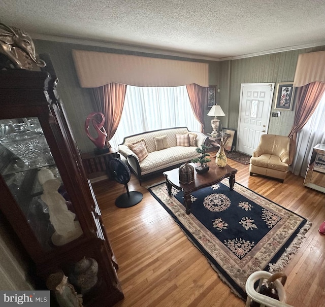 719 E 25th St, Chester, PA 19013 - living room featuring a textured ceiling, wood finished floors, and crown molding