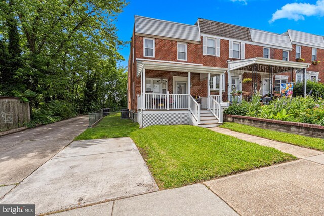 656 48th St, Baltimore, MD 21224 - view of property with a porch, brick siding, and mansard roof