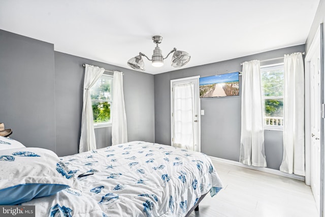 656 48th St, Baltimore, MD 21224 - bedroom with a chandelier, baseboards, and light wood-style floors