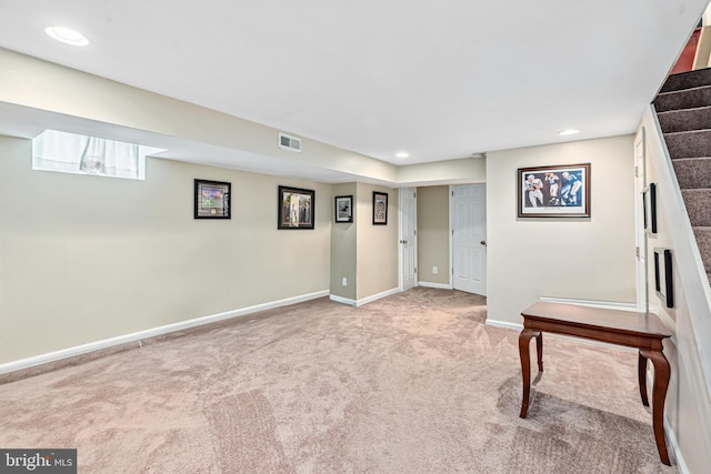 656 48th St, Baltimore, MD 21224 - finished below grade area with light carpet, stairs, baseboards, and recessed lighting