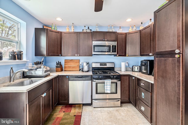 656 48th St, Baltimore, MD 21224 - kitchen with stainless steel appliances, a sink, light countertops, dark brown cabinets, and recessed lighting